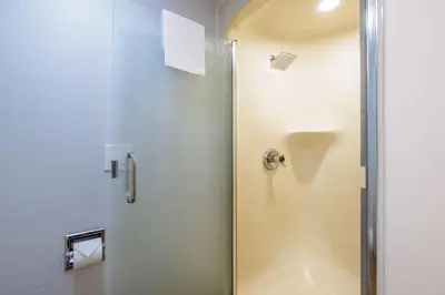 a shower with a glass door in a bathroom at Motel 6-Auburn, CA in Auburn