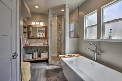 a bathroom with a tub and a shower and a sink at Sierra Sunset Inn - 3 Miles to Placerville! in Placerville