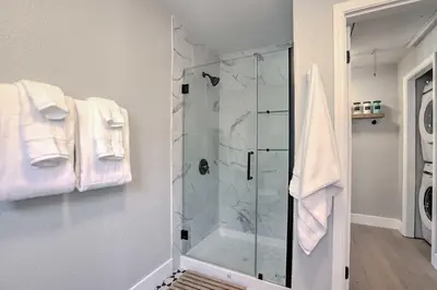 a bathroom with a shower with a glass door at Hot Tub, Fire Pit Midtown Reno Oasis! in Reno