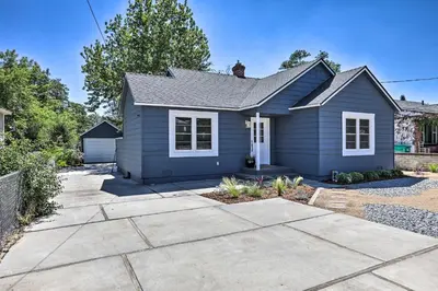 a blue house with a driveway at Hot Tub, Fire Pit Midtown Reno Oasis! in Reno
