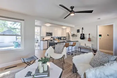 a living room with a couch and a table at Hot Tub, Fire Pit Midtown Reno Oasis! in Reno