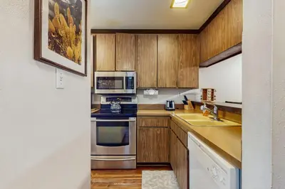 a kitchen with stainless steel appliances and wooden cabinets at Lakeside Dreamzzz in Tahoe Vista