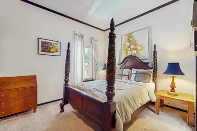 a bedroom with a bed and a dresser and a window at Lakeside Dreamzzz in Tahoe Vista