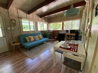 a living room with a blue couch and a table at Private 1 Bd near Yosemite and Bass lake in Oakhurst