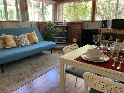 a living room with a blue couch and a table at Private 1 Bd near Yosemite and Bass lake in Oakhurst