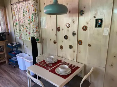 a dining room with a table and chairs and a lamp at Private 1 Bd near Yosemite and Bass lake in Oakhurst