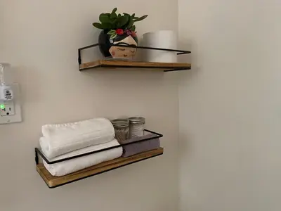 a bathroom with a shelf with towels and a plant at Private 1 Bd near Yosemite and Bass lake in Oakhurst