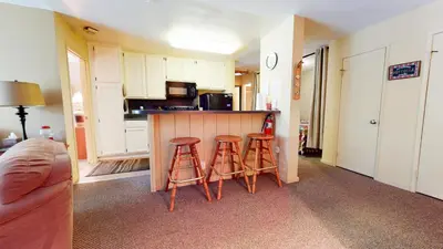 a kitchen with two stools and a counter in a room at Crestview #25 condo in Mammoth Lakes