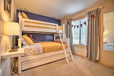 a bedroom with a bunk bed with a ladder at Cozy Family Condo in Mammoth Lakes with Balcony in Mammoth Lakes