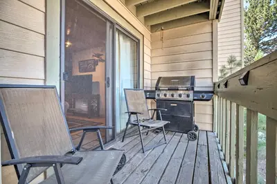 a screened in porch with two chairs and a grill at Cozy Family Condo in Mammoth Lakes with Balcony in Mammoth Lakes