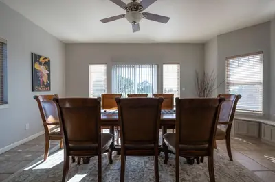 a dining room with a table and chairs and a ceiling fan at Fraser Family Vineyard Estate Pet-Friendly Home in Plymouth