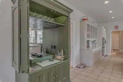 a large kitchen with green cabinets in a room at Fraser Family Vineyard Estate Pet-Friendly Home in Plymouth