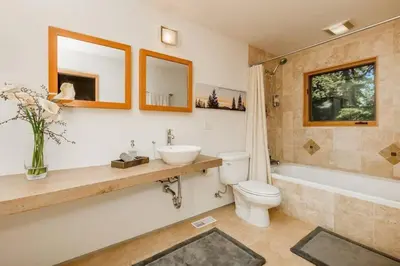a bathroom with a toilet and a sink and a tub at Tahoe Donner Luxury, Sleeps 14, Hot tub, 3100 sqft in Truckee