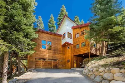 a large wooden house with a garage at Tahoe Donner Luxury, Sleeps 14, Hot tub, 3100 sqft in Truckee