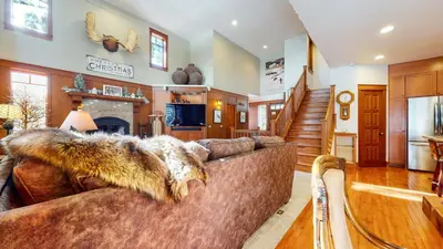 a living room with a couch and a fireplace at Timbers #10 townhouse in Mammoth Lakes