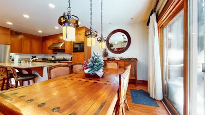 a kitchen and dining room with a wooden table at Timbers #10 townhouse in Mammoth Lakes