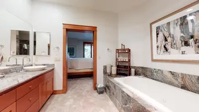 a bathroom with a tub and a sink at Timbers #10 townhouse in Mammoth Lakes