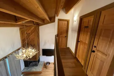 a hallway of a house with a chandelier at DNA Chalet - Newly Renovated Townhome @ Northstar in Truckee