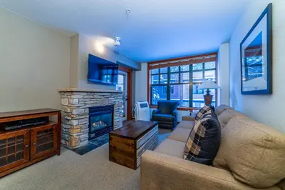a living room with a couch and a fireplace at Luxury Oasis Village Ski-in Ski-out in Mammoth Lakes