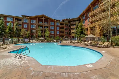 a large swimming pool in a resort building at Luxury Oasis Village Ski-in Ski-out in Mammoth Lakes