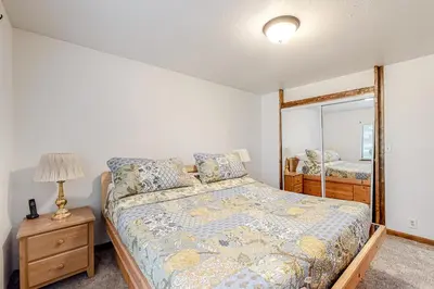 a bedroom with a bed and a mirror at Sierra Dream in South Lake Tahoe