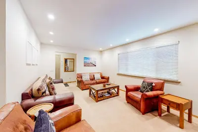 a living room with leather furniture and a window at Relax on Pretoria in Carnelian Bay