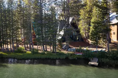 a view of a house from the water of a lake at Serene Lakes Splendor in Soda Springs