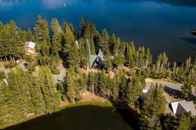an aerial view of a house on a hill with trees at Serene Lakes Splendor in Soda Springs