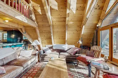 a living room with a couch and a table at Serene Lakes Splendor in Soda Springs