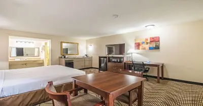 a hotel room with a bed and a table at Best Western Roseville Inn in Roseville