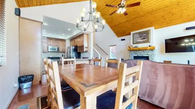 a dining room and kitchen with a wooden table and chairs at Mammoth Gateway Village #7 condo in Mammoth Lakes