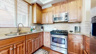 a kitchen with wooden cabinets and a stove top oven at Mammoth Gateway Village #7 condo in Mammoth Lakes