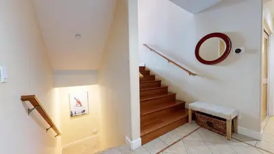 a hallway with a staircase with a mirror and a mirror at Mammoth Gateway Village #7 condo in Mammoth Lakes
