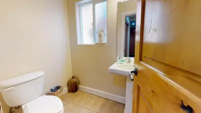a bathroom with a toilet and a sink and a window at Mammoth Gateway Village #7 condo in Mammoth Lakes