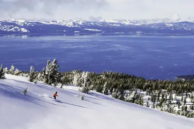 a person is skiing down a snow covered slope at Luxury Two Bedroom Residence steps from Heavenly Village condo in South Lake Tahoe