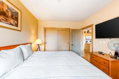 a bedroom with a bed and a flat screen tv at Juniper Springs 444 in Mammoth Lakes