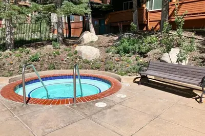 a small swimming pool with a bench next to it at Juniper Springs 444 in Mammoth Lakes
