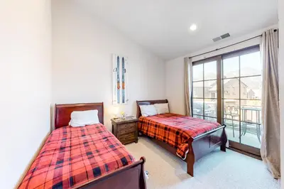 a bedroom with two beds and a window at Creekhouse 1332 in Mammoth Lakes