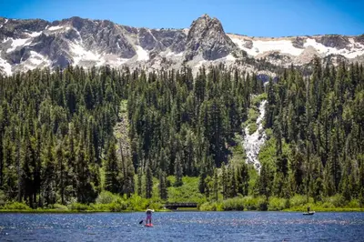two people in a lake in front of a mountain at Creekhouse 1332 in Mammoth Lakes