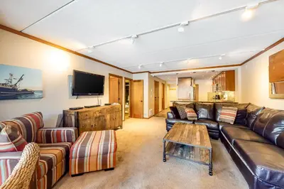 a living room with leather furniture and a flat screen tv at Condos 1849 #102 in Mammoth Lakes