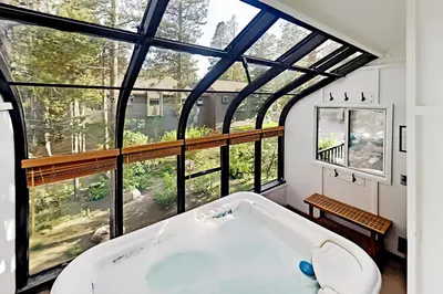 a bath tub in a room with a large window at Forest Creek 12 in Mammoth Lakes