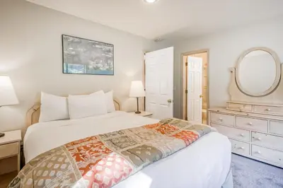 a bedroom with a bed and a dresser and a mirror at Through the Trees in Truckee