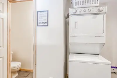 a kitchen with a stove and a white refrigerator at Through the Trees in Truckee