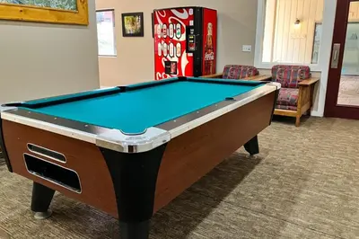 a pool table in a living room with at Mammoth Ski & Racquet 20 in Mammoth Lakes