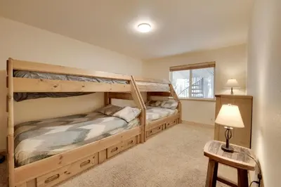 two bunk beds in a room with a lamp at Near Donner Lake and Skiing Soda Springs Cabin! in Soda Springs