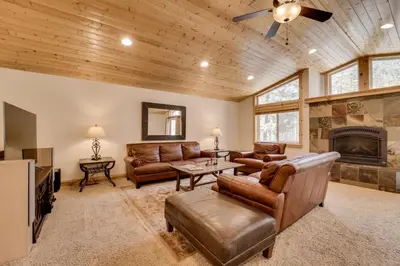 a living room with leather furniture and a fireplace at Near Donner Lake and Skiing Soda Springs Cabin! in Soda Springs