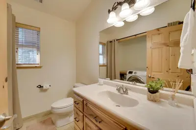a bathroom with a sink and a toilet and a mirror at Near Donner Lake and Skiing Soda Springs Cabin! in Soda Springs