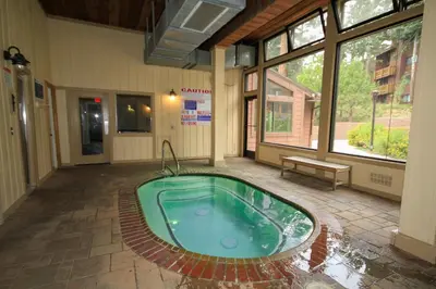a hot tub in the middle of a building at Mammoth Ski Racquet Club 32 - Newly Remodeled Pet Friendly in Mammoth Lakes