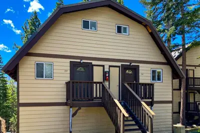 a house with a gambrel roof and a porch at Mammoth View Villas 24 in Mammoth Lakes
