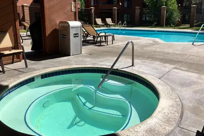 a swimming pool with a tub in the middle at Sunrise 8 in Mammoth Lakes